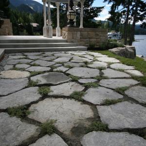 Whistler lakeside terrace with paving stones and natural rock shoreline