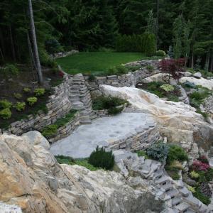 Garden terraces created with low stone retaining walls and planting