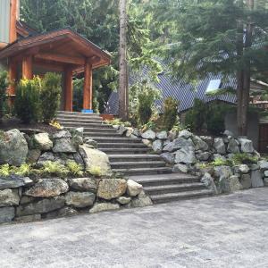 Home entrance framed by stone retaining walls and steps